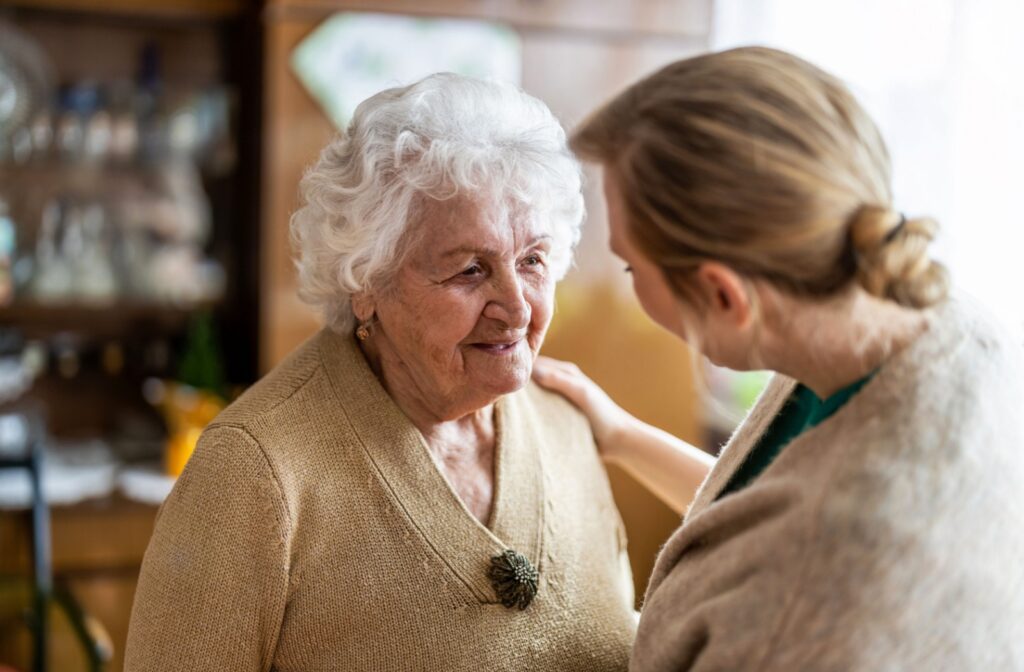 An adult child talks with their senior parent about assisted living.