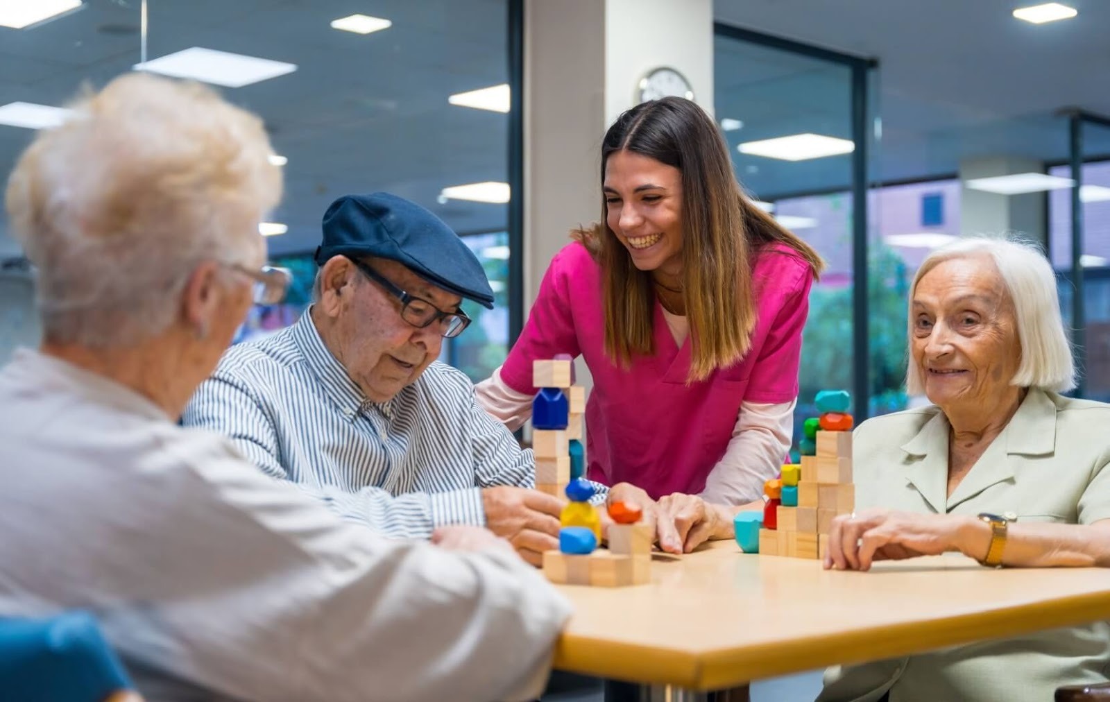 A caregiver assists a group of seniors with cognitive exercises