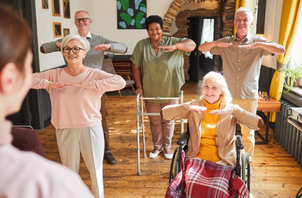 A group of older adults in assisted living enjoy a light stretching andactivity session at their assisted living community.